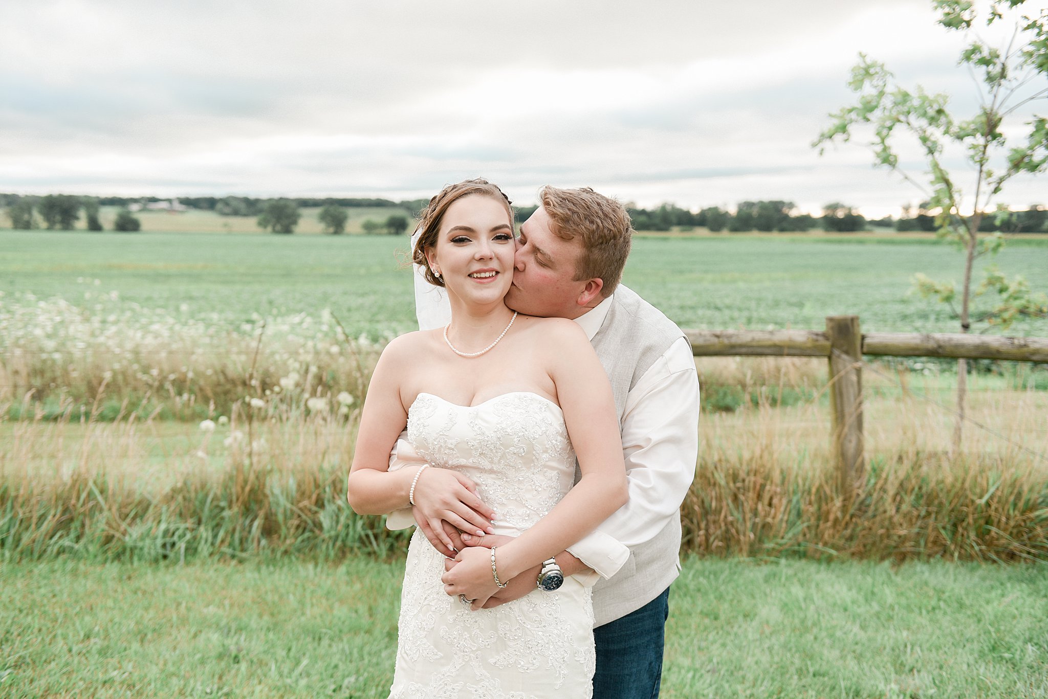 Couple embraces for a portrait during Wren Farm Wedding