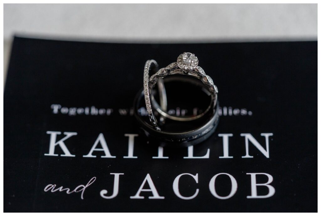 wedding rings on top of wedding invitation 