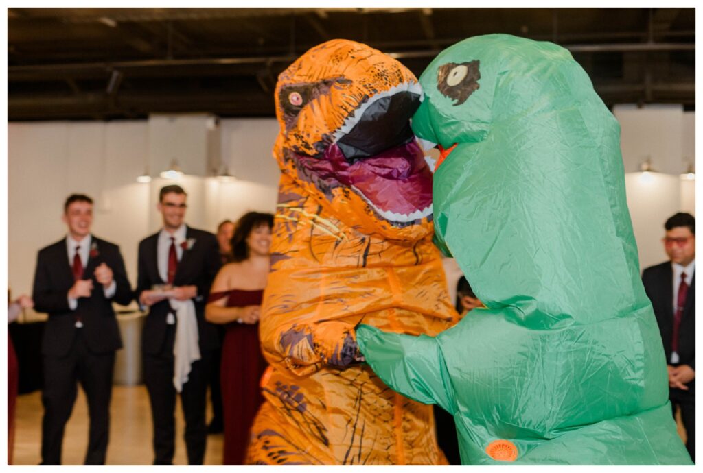 bridal party entrances, dressed up in dinosaur costumes 