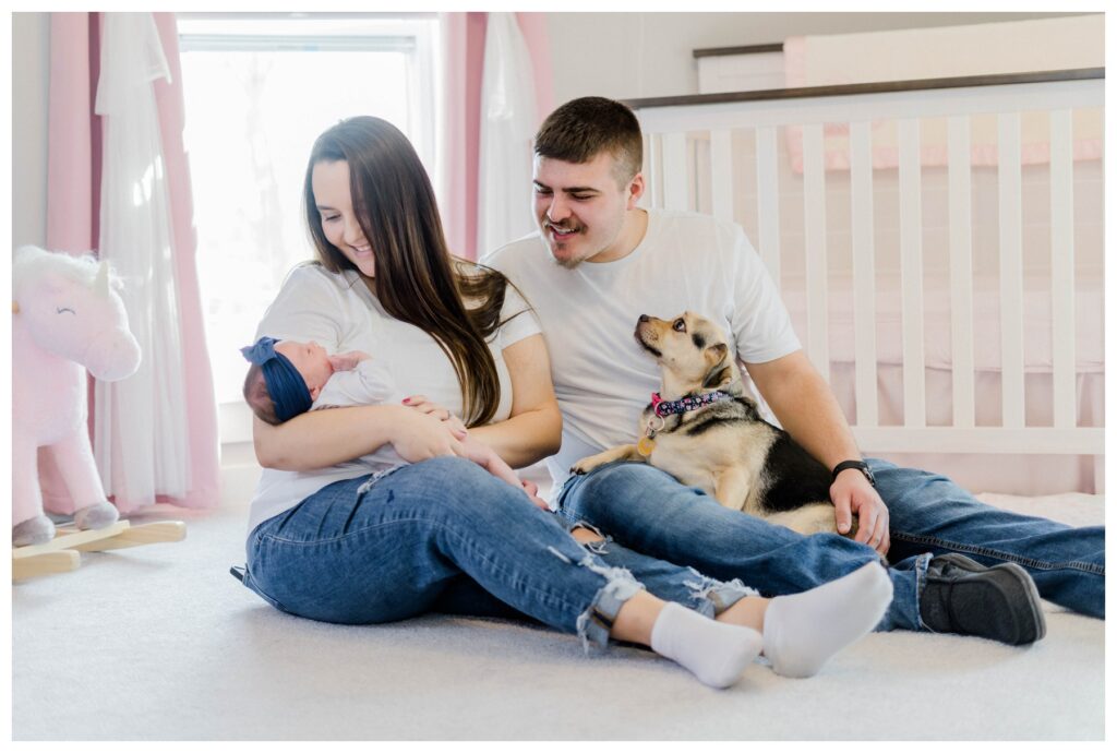 Mom, Dad, and Newborn baby sitting in their own home for session